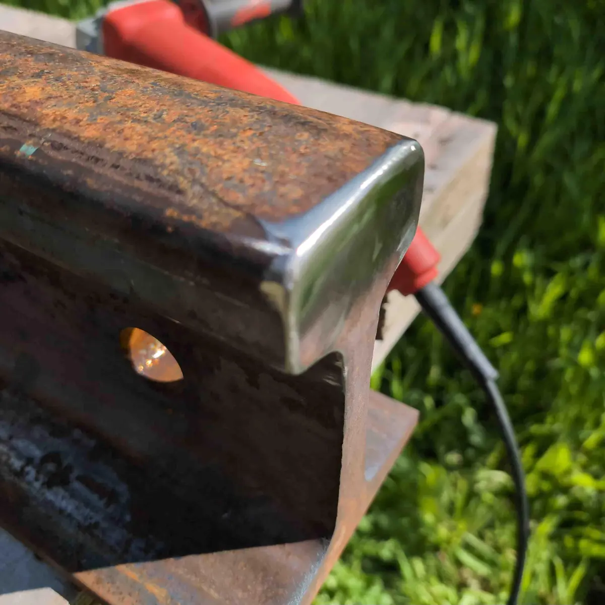 An angle shot showing the now rounded edges of the striking face of the rail anvil.