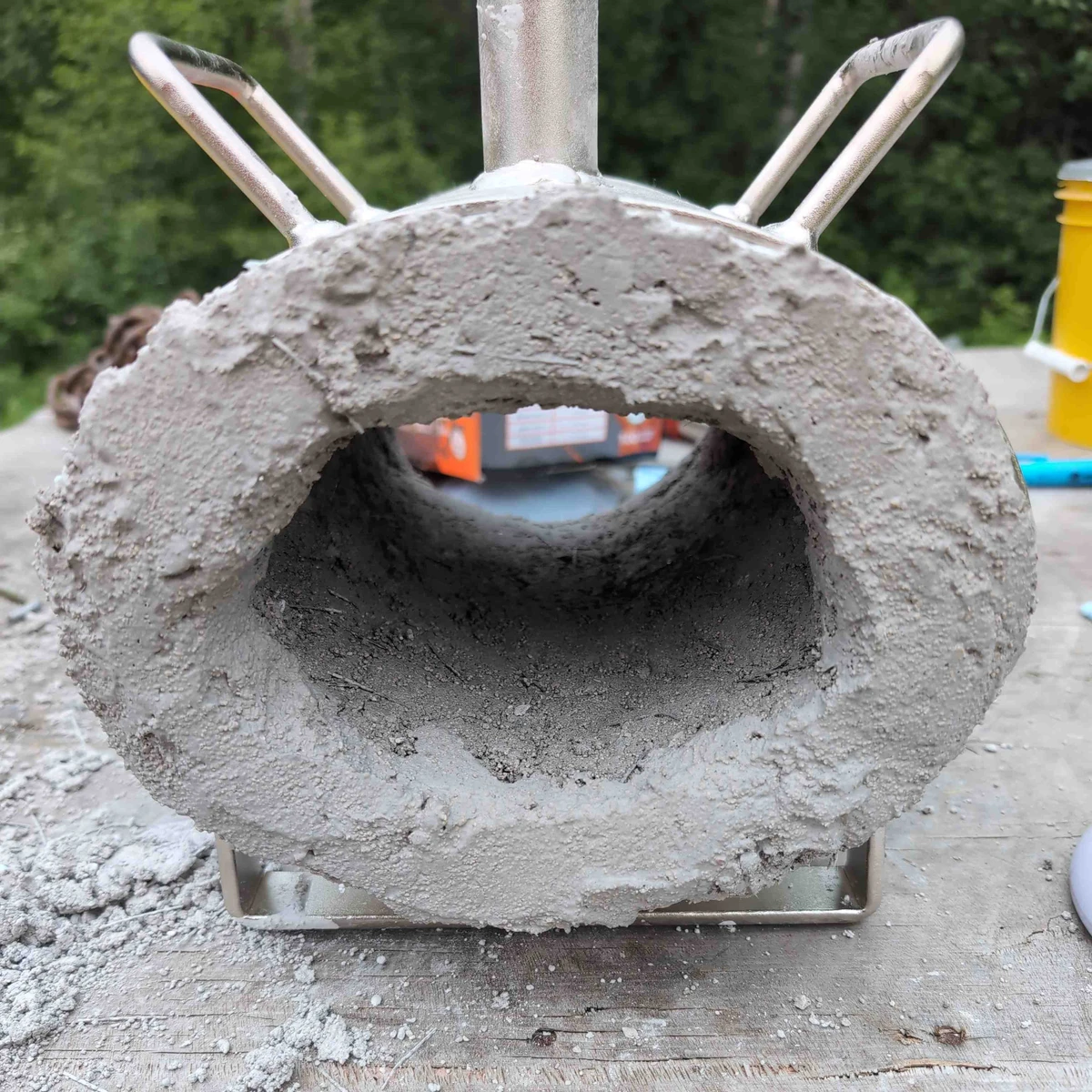 First coat of refractory cement on a forge that has a rough, uneven texture.